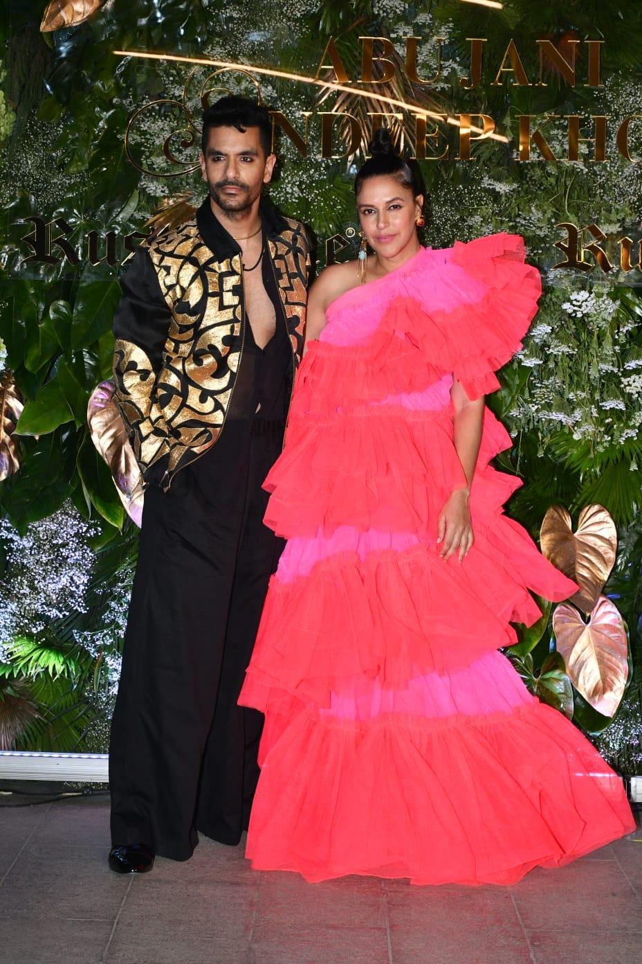 The celebrity couple Neha Dhupia and Angad Bedi opted for a contrasting look where Dhupia wore an eccentric dual toned dress styled with a sleek high bun and Angad wore an all-black ensemble, topped with a gold detailed black jacket and a subtle kajal for the eyes. 
